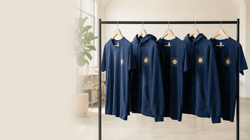 Finished custom printed garments hanging on studio rail