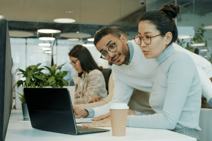 Two colleagues working together at a laptop