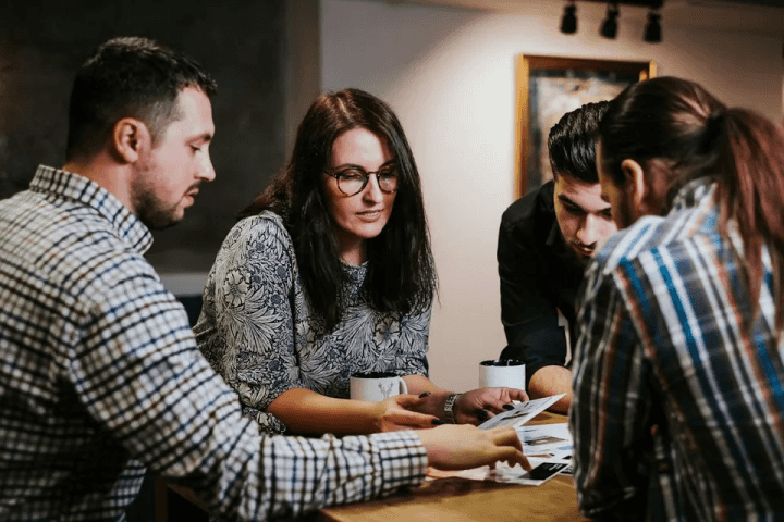 Colleagues reviewing printed samples at a table
